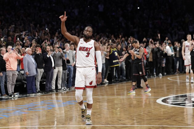 Miami Heat guard Dwyane Wade (3) acknowledges the crowd's cheers after playing in the final NBA basketball game of his career, against the Brooklyn Nets on Wednesday, April 10, 2019, in New York. (AP Photo/Kathy Willens)