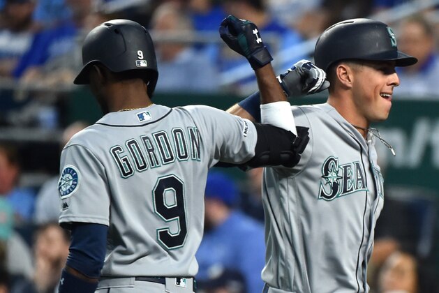 KANSAS CITY, MISSOURI - APRIL 08:  Dylan Moore #25 of the Seattle Mariners is congratulated by Dee Gordon #9 after hitting a home run against the Kansas City Royals in the second inning at Kauffman Stadium on April 08, 2019 in Kansas City, Missouri. (Photo by Ed Zurga/Getty Images)