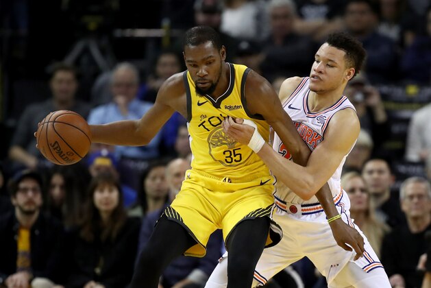 OAKLAND, CALIFORNIA - JANUARY 08:  Kevin Durant #35 of the Golden State Warriors is guarded by Kevin Knox #20 of the New York Knicks at ORACLE Arena on January 08, 2019 in Oakland, California. NOTE TO USER: User expressly acknowledges and agrees that, by downloading and or using this photograph, User is consenting to the terms and conditions of the Getty Images License Agreement. (Photo by Ezra Shaw/Getty Images)
