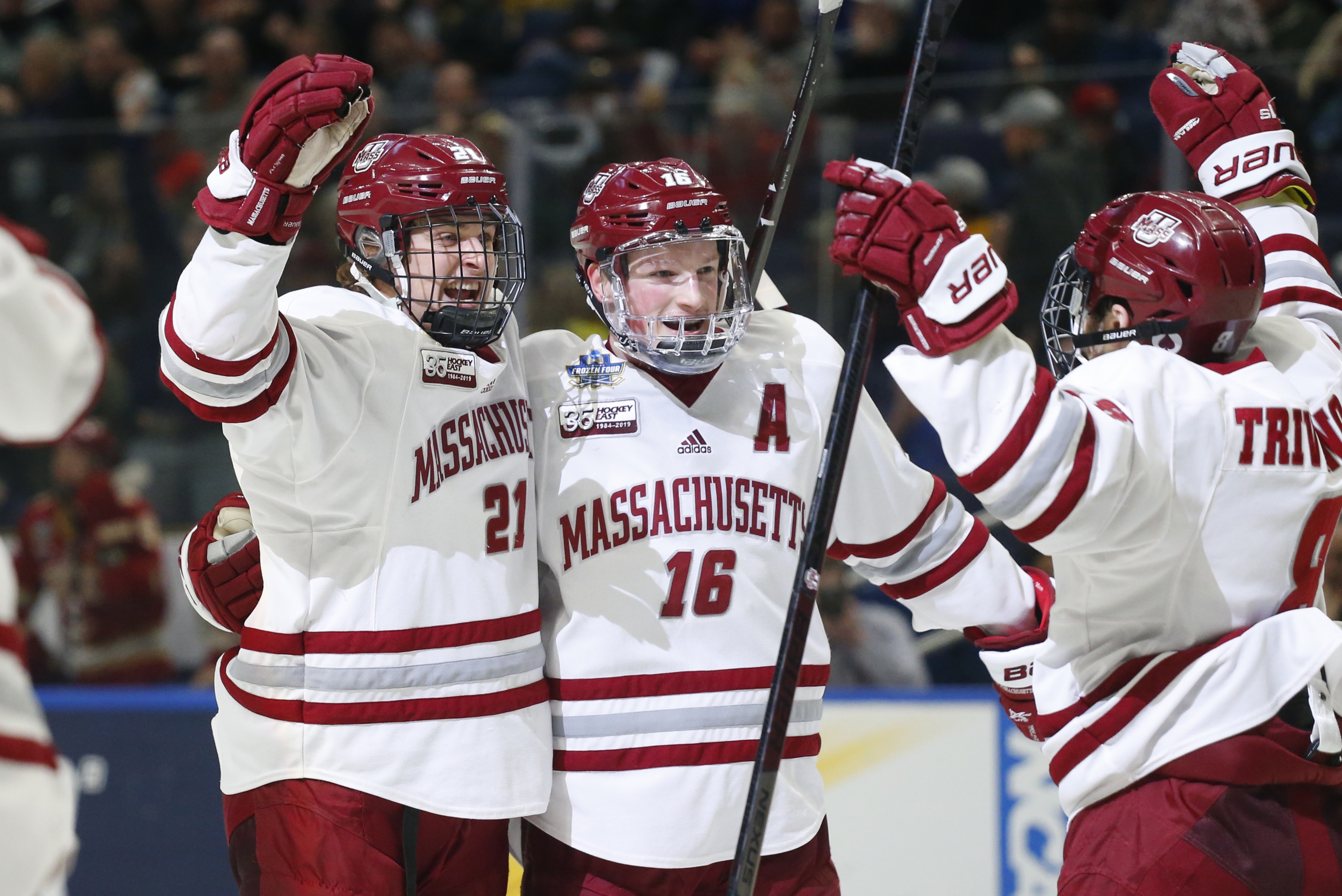 Massachusetts' Mitchell Chaffee (21) and Cale Makar (16) celebrate a goal against Denver during the first period in a semifinal of the Frozen Four NCAA men's college hockey tournament Thursday, April 11, 2019, in Buffalo, N.Y. (AP Photo/Jeffrey T. Barnes)