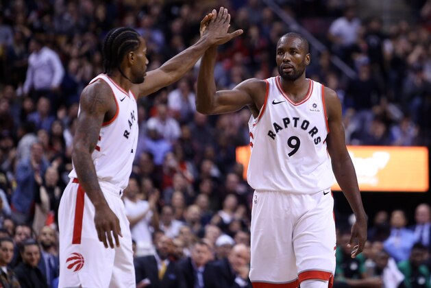 TORONTO, ON - OCTOBER 19:  Kawhi Leonard #2 and Serge Ibaka #9 of the Toronto Raptors react late in the second half of an NBA game against the Boston Celtics at Scotiabank Arena on October 19, 2018 in Toronto, Canada.  NOTE TO USER: User expressly acknowledges and agrees that, by downloading and or using this photograph, User is consenting to the terms and conditions of the Getty Images License Agreement.  (Photo by Vaughn Ridley/Getty Images)