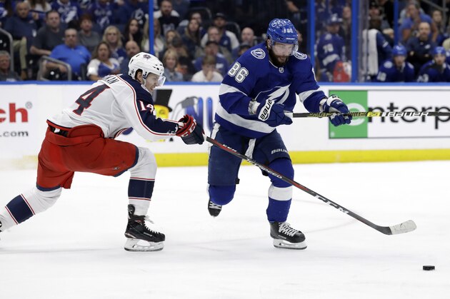 Columbus Blue Jackets defenseman Dean Kukan (14) tips the puck away from Tampa Bay Lightning right wing Nikita Kucherov (86) during the second period of Game 1 of an NHL Eastern Conference first-round hockey playoff series Wednesday, April 10, 2019, in Tampa, Fla. (AP Photo/Chris O'Meara)
