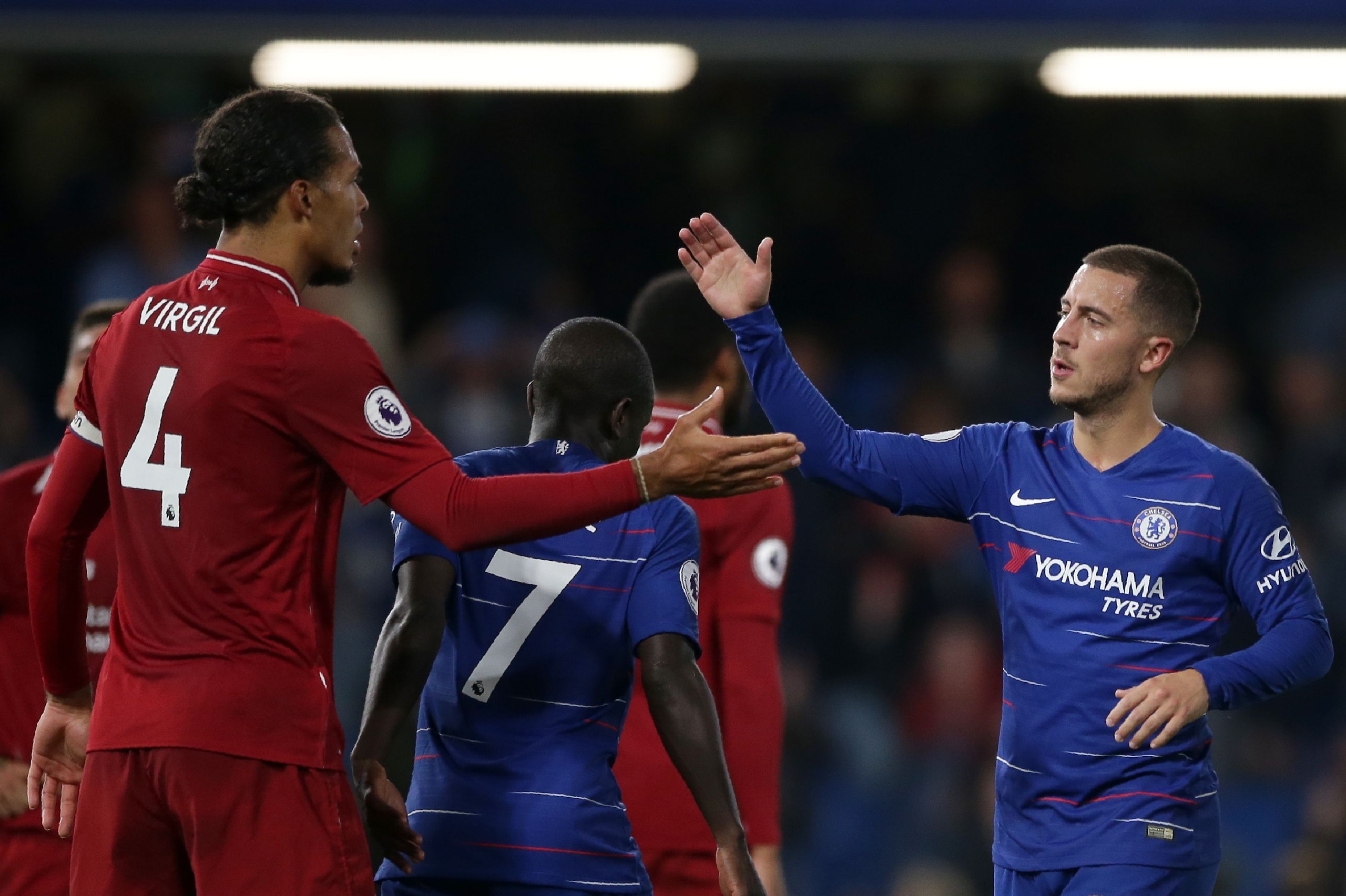 Liverpool's Dutch defender Virgil van Dijk (L) and Chelsea's Belgian midfielder Eden Hazard shake hands after the English Premier League football match between Chelsea and Liverpool at Stamford Bridge in London on September 29, 2018. (Photo by Daniel LEAL-OLIVAS / AFP) / RESTRICTED TO EDITORIAL USE. No use with unauthorized audio, video, data, fixture lists, club/league logos or 'live' services. Online in-match use limited to 120 images. An additional 40 images may be used in extra time. No video emulation. Social media in-match use limited to 120 images. An additional 40 images may be used in extra time. No use in betting publications, games or single club/league/player publications. /         (Photo credit should read DANIEL LEAL-OLIVAS/AFP/Getty Images)