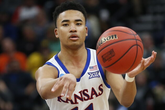 Kansas guard Devon Dotson (11) passes the ball against Northeastern in the second half during a first round men's college basketball game in the NCAA Tournament Thursday, March 21, 2019, in Salt Lake City. (AP Photo/Rick Bowmer)