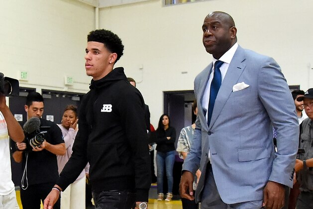 LOS ANGELES, CA - JUNE 23:  Lonzo Ball looks on and Magic Johnson, president of basketball operations of the Los Angeles Lakers arrive for a press conference on June 23, 2017 at the team training faculity in Los Angeles, California.  (Photo by Jayne Kamin-Oncea/Getty Images)