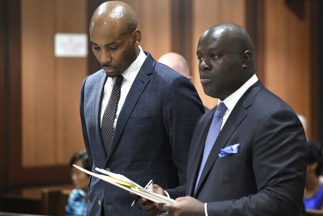 In this Thursday, Aug. 9, 2018, photo, Jamill Jones, left, appears in Queens Criminal Court in New York. The parents of a Florida man who died after he was punched by Jones, an assistant basketball coach at Wake Forest University, said Friday they don't accept the coach's condolences. (Barry Williams/Dailymail.com via AP, Pool)