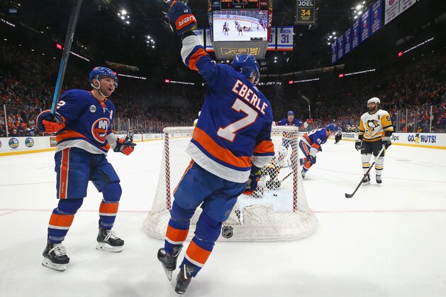 UNIONDALE, NEW YORK - APRIL 10: (l-r) Josh Bailey #12 and Jordan Eberle #7 of the New York Islanders celebrate a goal by Brock Nelson #29 against the Pittsburgh Penguins in Game One of the Eastern Conference First Round during the 2019 NHL Stanley Cup Playoffs at NYCB Live's Nassau Coliseum on April 10, 2019 in Uniondale, New York. The Islanders defeated the Penguins 4-3 in overtime. (Photo by Bruce Bennett/Getty Images)