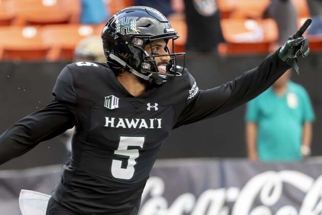 Hawaii wide receiver John Ursua (5) celebrates after catching a pass for a touchdown In the first half of an NCAA college football game against Navy, Saturday, Sept. 1, 2018, in Honolulu. (AP Photo/Eugene Tanner)