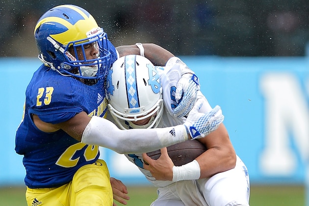 CHAPEL HILL, NC - SEPTEMBER 26: Nasir Adderley #22 of the Delaware Fightin Blue Hens tackles Mitch Trubisky #10 of the North Carolina Tar Heels during their game at Kenan Stadium on September 26, 2015 in Chapel Hill, North Carolina. North Carolina won 41-14.  (Photo by Grant Halverson/Getty Images)
