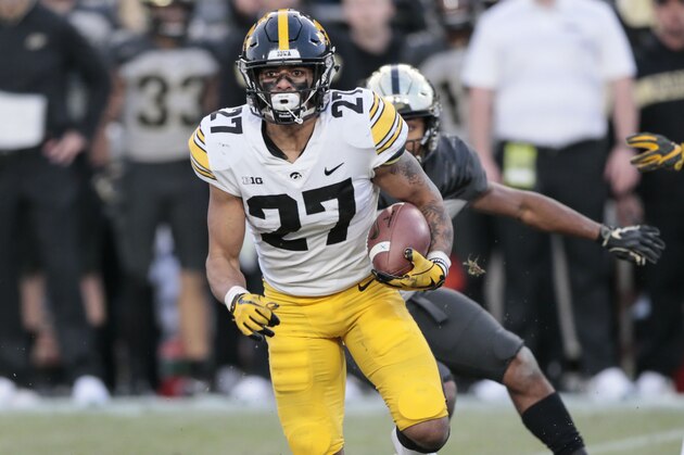 Iowa defensive back Amani Hooker (27) runs with the ball after intercepting it while playing Purdue in the second half of an NCAA college football game in West Lafayette, Ind., Saturday, Nov. 3, 2018. (AP Photo/AJ Mast)