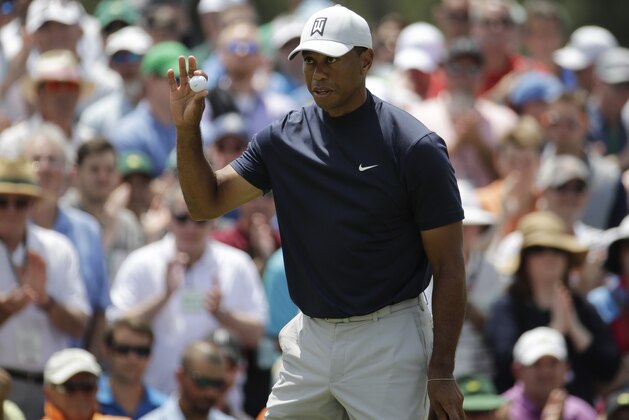 Tiger Woods reacts on the ninth hole during the first round for the Masters golf tournament Thursday, April 11, 2019, in Augusta, Ga. (AP Photo/Charlie Riedel)