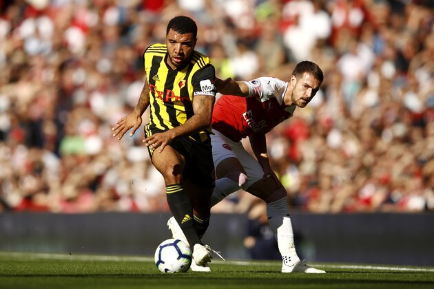LONDON, ENGLAND - SEPTEMBER 29:  Troy Deeney of Watford takes the ball away from Aaron Ramsey (R) of Arsenal during the Premier League match between Arsenal FC and Watford FC at Emirates Stadium on September 29, 2018 in London, United Kingdom.  (Photo by Julian Finney/Getty Images)