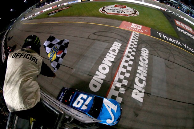 RICHMOND, VA - APRIL 13:  Martin Truex Jr, driver of the #19 Auto Owners Insurance Toyota, takes the checkered flag to win the Monster Energy NASCAR Cup Series Toyota Owners 400 at Richmond Raceway on April 13, 2019 in Richmond, Virginia.  (Photo by Sean Gardner/Getty Images)