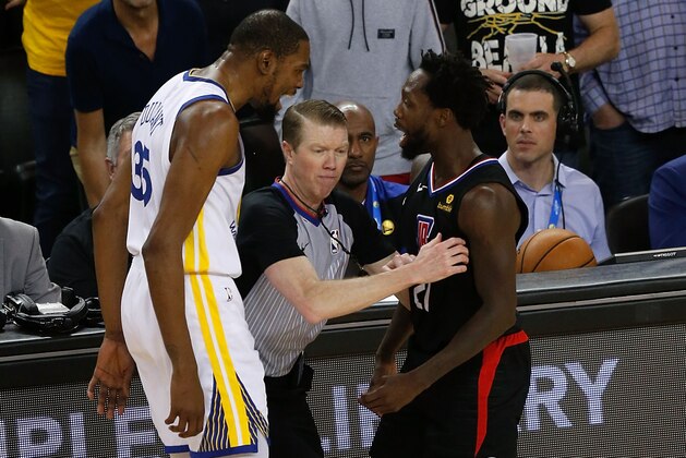 OAKLAND, CA - APRIL 13: Kevin Durant #35 of the Golden State Warriors exchanges words with Patrick Beverley #21 of the LA Clippers during Game One of the first round of the 2019 NBA Western Conference Playoffs at ORACLE Arena on April 13, 2019 in Oakland, California. NOTE TO USER: User expressly acknowledges and agrees that, by downloading and or using this photograph, User is consenting to the terms and conditions of the Getty Images License Agreement. (Photo by Lachlan Cunningham/Getty Images)