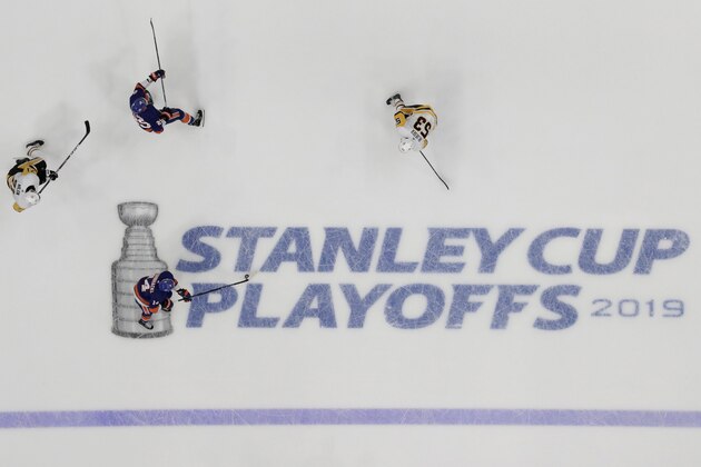 New York Islanders right wing Tom Kuhnhackl (14), of Germany, skates with the puck against Pittsburgh Penguins center Evgeni Malkin (71), of Russia, and center Teddy Blueger (53), of Latvia, during the second period of Game 2 of an NHL hockey first-round playoff series, Friday, April 12, 2019, in Uniondale, N.Y. Islanders' Brock Nelson (29) skates is at top. The Islanders won 3-1. (AP Photo/Julio Cortez)