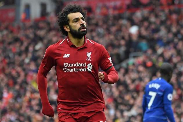 Liverpool's Egyptian midfielder Mohamed Salah celebrates after scoring their second goal during the English Premier League football match between Liverpool and Chelsea at Anfield in Liverpool, north west England on April 14, 2019. (Photo by Paul ELLIS / AFP) / RESTRICTED TO EDITORIAL USE. No use with unauthorized audio, video, data, fixture lists, club/league logos or 'live' services. Online in-match use limited to 120 images. An additional 40 images may be used in extra time. No video emulation. Social media in-match use limited to 120 images. An additional 40 images may be used in extra time. No use in betting publications, games or single club/league/player publications. /         (Photo credit should read PAUL ELLIS/AFP/Getty Images)