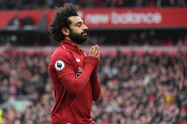 Liverpool's Egyptian midfielder Mohamed Salah celebrates after scoring their second goal during the English Premier League football match between Liverpool and Chelsea at Anfield in Liverpool, north west England on April 14, 2019. (Photo by Paul ELLIS / AFP) / RESTRICTED TO EDITORIAL USE. No use with unauthorized audio, video, data, fixture lists, club/league logos or 'live' services. Online in-match use limited to 120 images. An additional 40 images may be used in extra time. No video emulation. Social media in-match use limited to 120 images. An additional 40 images may be used in extra time. No use in betting publications, games or single club/league/player publications. /         (Photo credit should read PAUL ELLIS/AFP/Getty Images)