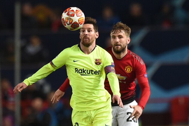 Barcelona's Argentinian forward Lionel Messi (L) vies with Manchester United's English defender Luke Shaw during the UEFA Champions league first leg quarter-final football match between Manchester United and Barcelona at Old Trafford in Manchester, north west England, on April 10, 2019. (Photo by Oli SCARFF / AFP)        (Photo credit should read OLI SCARFF/AFP/Getty Images)