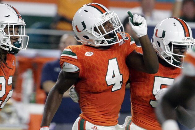 FILE - In this Nov. 11, 2017, file photo, Miami defensive back Jaquan Johnson (4) celebrates after intercepting Notre Dame quarterback Brandon Wimbush during the first half of an NCAA college football game, in Miami Gardens, Fla. Johnson was selected to the AP Preseason All-America team, Tuesday, Aug. 21, 2018. (AP Photo/Lynne Sladky, File)