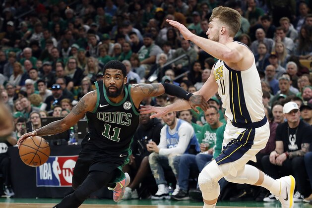 Boston Celtics' Kyrie Irving drives on Indiana Pacers' Domantas Sabonisn during the second quarter in Game 1 of a first-round NBA basketball playoff series, Sunday, April 14, 2019, in Boston. (AP Photo/Winslow Townson)