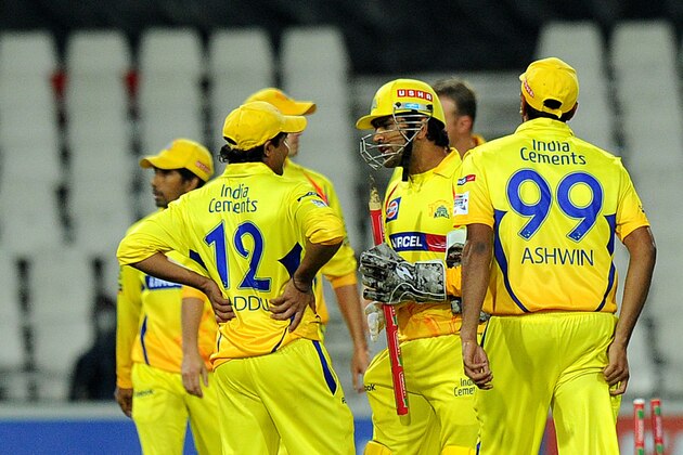 Chennal Super Kings wicketkeeper Mahendra Singh Dhoni (C) celebrates winning Mumbai Indians by six wickets on October 20, 2012 during a Group B  Champions League T20 (CLT20) match at Wanderers Stadium in Johannesburg.                 AFP PHOTO / ALEXANDER JOE        (Photo credit should read ALEXANDER JOE/AFP/Getty Images)