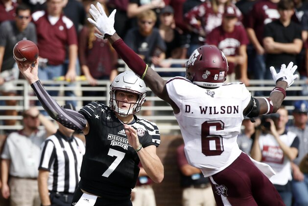 Mississippi State quarterback Nick Fitzgerald (7) throws past the defense of Texas A&M defensive back Donovan Wilson (6) during the second half of their NCAA college football game in Starkville, Miss., Saturday, Nov. 5, 2016. Mississippi State won 35-28. (AP Photo/Rogelio V. Solis)
