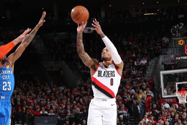 PORTLAND, OR - APRIL 14:  Damian Lillard #0 of the Portland Trail Blazers shoots the ball against the Oklahoma City Thunder during Game One of Round One of the 2019 NBA Playoffs on April 14, 2019 at the Moda Center Arena in Portland, Oregon. NOTE TO USER: User expressly acknowledges and agrees that, by downloading and or using this photograph, user is consenting to the terms and conditions of the Getty Images License Agreement. Mandatory Copyright Notice: Copyright 2019 NBAE (Photo by Zach Beeker/NBAE via Getty Images)
