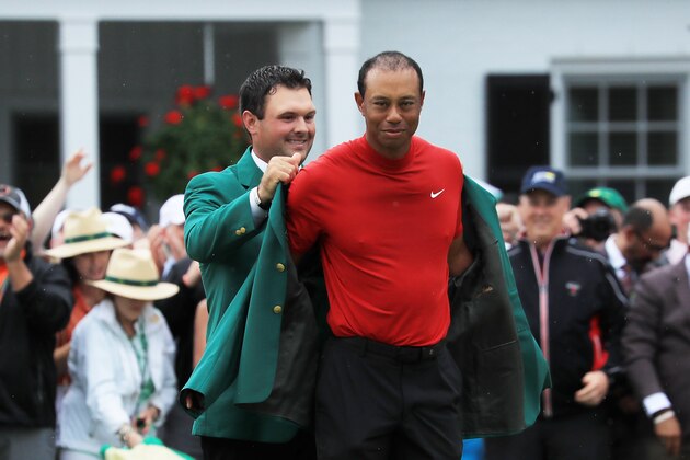AUGUSTA, GEORGIA - APRIL 14: Tiger Woods (R) of the United States is awarded the Green Jacket by Masters champion Patrick Reed (L) during the Green Jacket Ceremony after winning the Masters at Augusta National Golf Club on April 14, 2019 in Augusta, Georgia. (Photo by David Cannon/Getty Images)