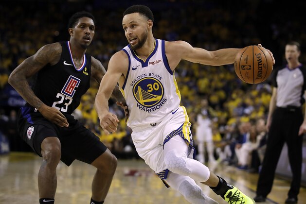 Golden State Warriors' Stephen Curry, right, drives the ball around Los Angeles Clippers' Lou Williams (23) during the second half in Game 1 of a first-round NBA basketball playoff series Saturday, April 13, 2019, in Oakland, Calif. (AP Photo/Ben Margot)