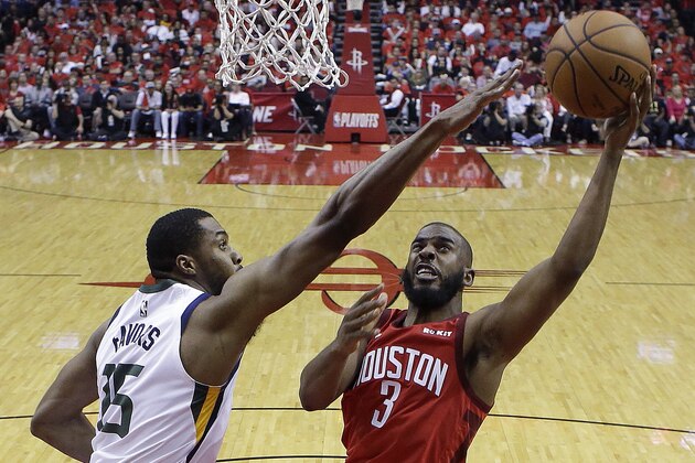 Houston Rockets guard Chris Paul (3) shoots as Utah Jazz forward Derrick Favors defends during the second half of Game 1 of an NBA basketball first-round playoff series, Sunday, April 14, 2019, in Houston. Houston won the game 122-90. (AP Photo/Eric Christian Smith)