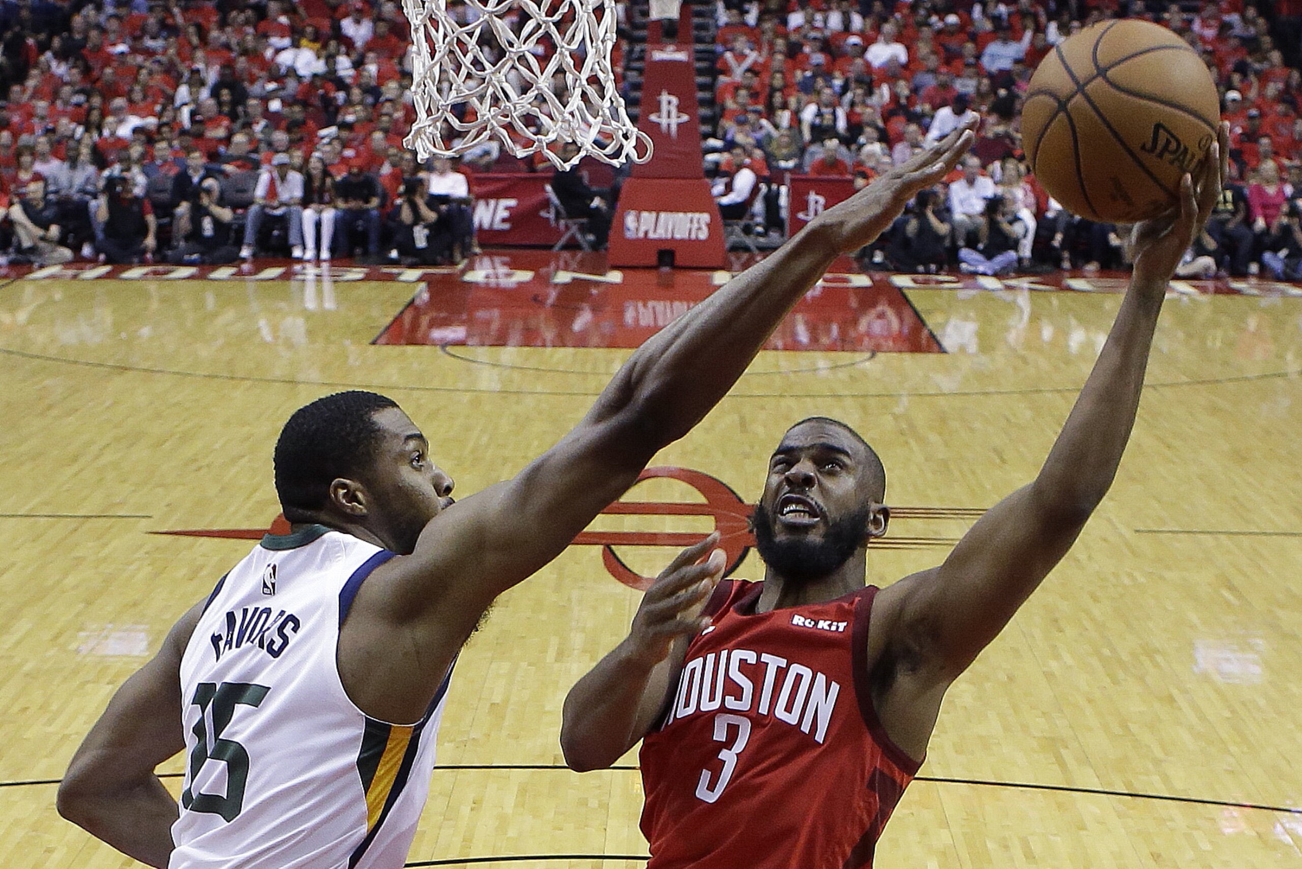 Houston Rockets guard Chris Paul (3) shoots as Utah Jazz forward Derrick Favors defends during the second half of Game 1 of an NBA basketball first-round playoff series, Sunday, April 14, 2019, in Houston. Houston won the game 122-90. (AP Photo/Eric Christian Smith)