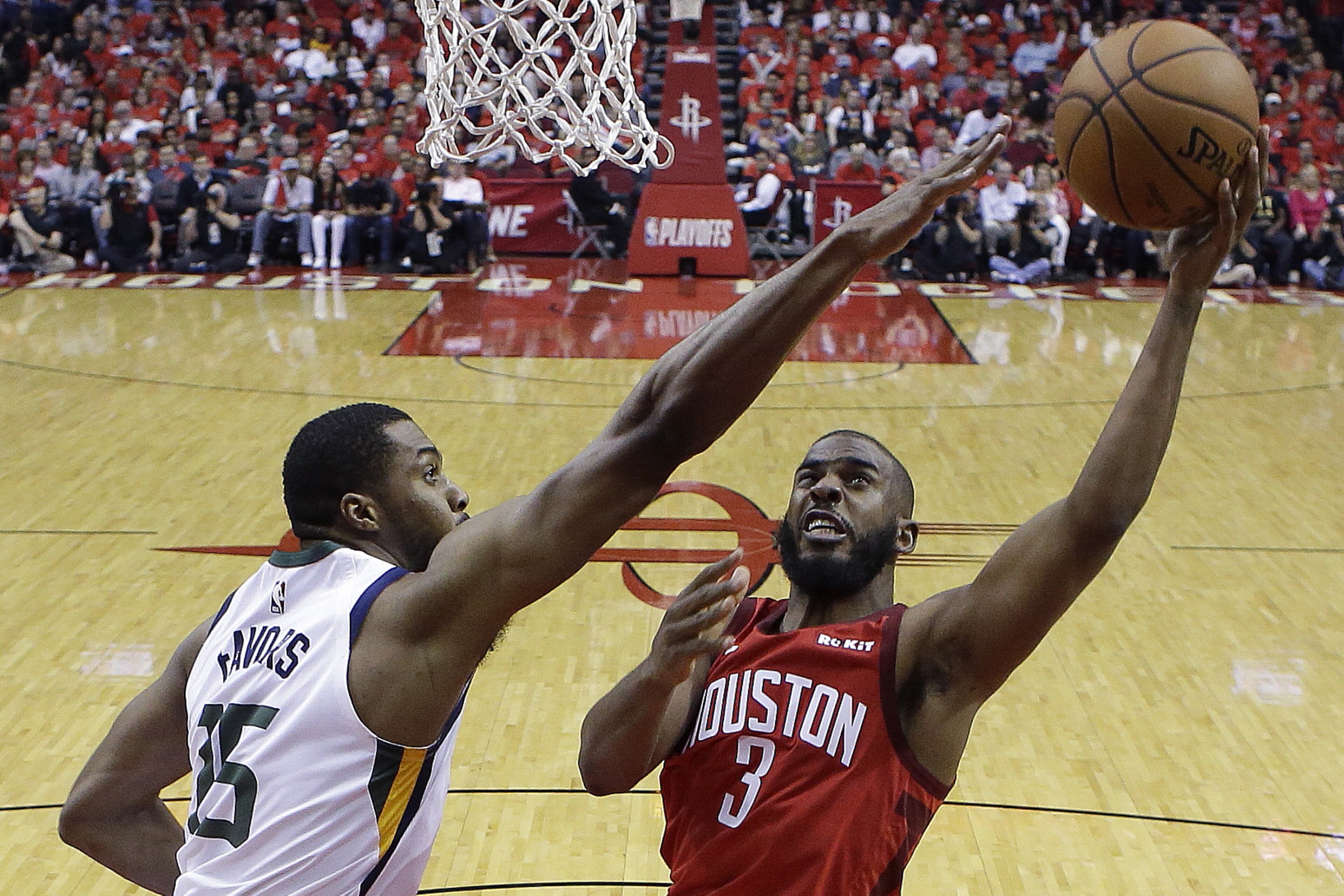 Houston Rockets guard Chris Paul (3) shoots as Utah Jazz forward Derrick Favors defends during the second half of Game 1 of an NBA basketball first-round playoff series, Sunday, April 14, 2019, in Houston. Houston won the game 122-90. (AP Photo/Eric Christian Smith)