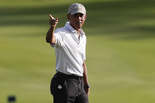 President Barack Obama walks across the 18th green at Kapolei Golf Club, in Kapolei, Hawaii, Wednesday, Dec. 21, 2016. (AP Photo/Carolyn Kaster)