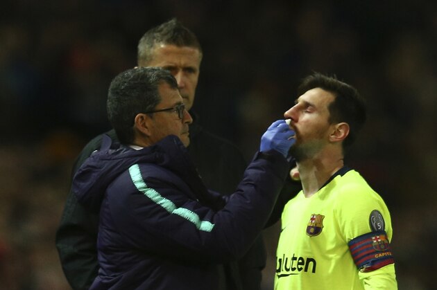 Barcelona's Lionel Messi receives medical assistance during the Champions League quarterfinal, first leg, soccer match between Manchester United and FC Barcelona at Old Trafford stadium in Manchester, England, Wednesday, April 10, 2019. (AP Photo/Dave Thompson)