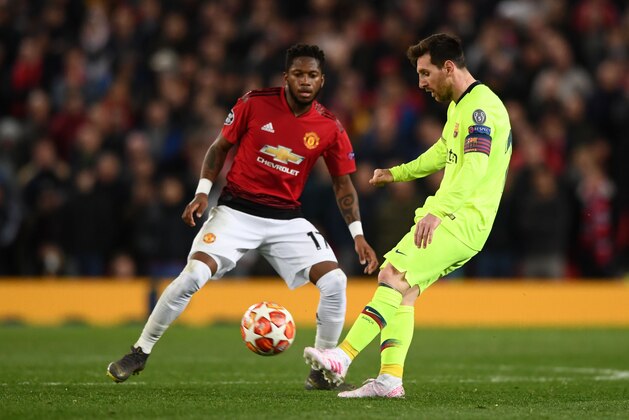 MANCHESTER, ENGLAND - APRIL 10: Barcelona player Lionel Messi in action as Fred looks on during the UEFA Champions League Quarter Final first leg match between Manchester United and FC Barcelona at Old Trafford on April 10, 2019 in Manchester, England. (Photo by Stu Forster/Getty Images)