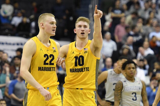 WASHINGTON, DC - JANUARY 15:  Joey Hauser #22 and #Sam Hauser #10 of the Marquette Golden Eagles on the floor during a college basketball game against the Georgetown Hoyas at Capital One Arena on January 15, 2019 in Washington, DC.  (Photo by Mitchell Layton/Getty Images)