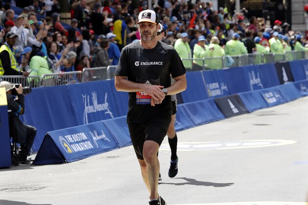 NASCAR driver Jimmie Johnson, of Charlotte, N.C., finishes the 123rd Boston Marathon on Monday, April 15, 2019, in Boston. (AP Photo/Winslow Townson)