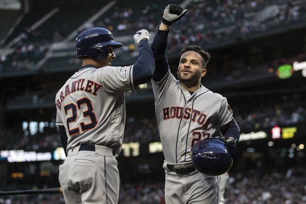 SEATTLE, WA - APRIL 13: Jose Altuve #27 of the Houston Astros is congratulated by Michael Brantley #23 of the Houston Astros after hitting a solo home run off of starting pitcher Felix Hernandez #34 of the Seattle Mariners during the fifth inning of a game at T-Mobile Park on April 13, 2019 in Seattle, Washington. (Photo by Stephen Brashear/Getty Images)