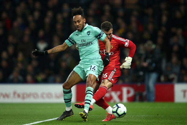 WATFORD, ENGLAND - APRIL 15:  Pierre-Emerick Aubameyang of Arsenal scores his side's first goal past Ben Foster of Watford during the Premier League match between Watford FC and Arsenal FC at Vicarage Road on April 15, 2019 in Watford, United Kingdom. (Photo by Marc Atkins/Getty Images)