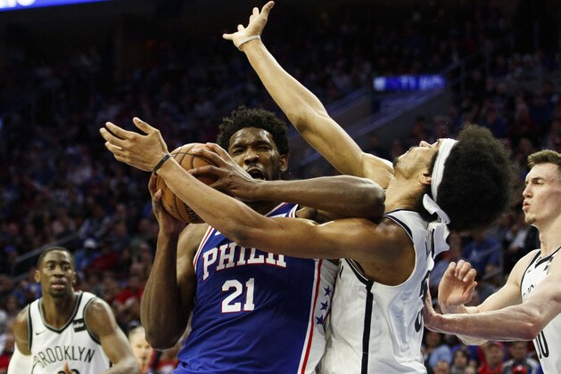 Philadelphia 76ers' Joel Embiid, left, of Cameroon, with the flaguant 1 foul on Brooklyn Nets' Jarrett Allen, right, as he was going for the shot during the first half in Game 2 of a first-round NBA basketball playoff series, Monday, April 15, 2019, in Philadelphia. (AP Photo/Chris Szagola)