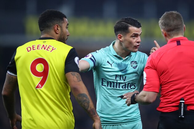 WATFORD, ENGLAND - APRIL 15:  Granit Xhaka of Arsenal remonstrates with Referee, Craig Pawson after Troy Deeney of Watford elbowed Lucas Torreira of Arsenal during the Premier League match between Watford FC and Arsenal FC at Vicarage Road on April 15, 2019 in Watford, United Kingdom. (Photo by Julian Finney/Getty Images)