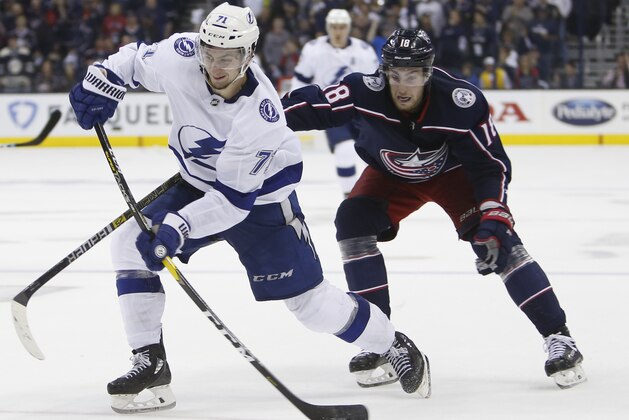 Tampa Bay Lightning's Anthony Cirelli, left, takes a shot as Columbus Blue Jackets' Pierre-Luc Dubois defends during the third period of Game 3 of an NHL hockey first-round playoff series, Sunday, April 14, 2019, in Columbus, Ohio. The Blue Jackets beat the Lightning 3-1. (AP Photo/Jay LaPrete)