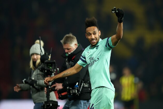 WATFORD, ENGLAND - APRIL 15:  Pierre-Emerick Aubameyang of Arsenal celebrates towards the traveling fans following his side's victory during the Premier League match between Watford FC and Arsenal FC at Vicarage Road on April 15, 2019 in Watford, United Kingdom. (Photo by Marc Atkins/Getty Images)