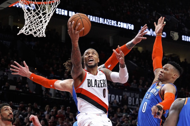 Portland Trail Blazers guard Damian Lillard, center, shoots as Oklahoma City Thunder guard Russell Westbrook, right, defends during the second half of Game 1 of a first-round NBA basketball playoff series in Portland, Ore., Sunday, April 14, 2019. (AP Photo/Steve Dipaola)