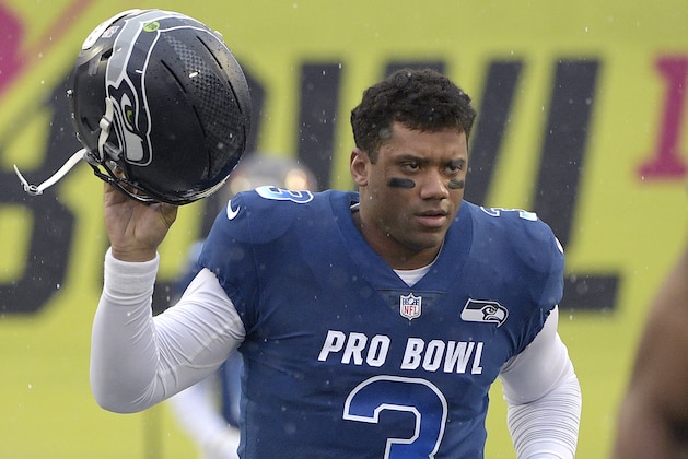 FILE - In this Jan. 27, 2019, file photo, NFC quarterback Russell Wilson of the Seattle Seahawks runs onto the field during player introductions before the NFL Pro Bowl football game against the AFC in Orlando, Fla. Wilson posted a video to social media early Tuesday, Apriil 16, 2019, saying,