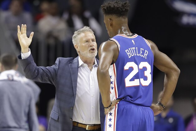 Philadelphia 76ers head coach Brett Brown, left, talks with Jimmy Butler (23) during the first half of an NBA basketball game against the Charlotte Hornets in Charlotte, N.C., Saturday, Nov. 17, 2018. (AP Photo/Chuck Burton)