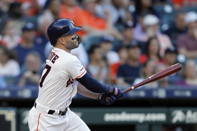 HOUSTON, TEXAS - APRIL 10: Jose Altuve #27 of the Houston Astros hits a home run in the first inning against the New York Yankees at Minute Maid Park on April 10, 2019 in Houston, Texas. (Photo by Bob Levey/Getty Images)