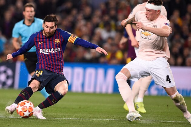 Barcelona's Argentinian forward Lionel Messi (L) scores  during the UEFA Champions League quarter-final second leg football match between Barcelona and Manchester United at the Camp Nou stadium in Barcelona on April 16, 2019. (Photo by Josep LAGO / AFP)        (Photo credit should read JOSEP LAGO/AFP/Getty Images)