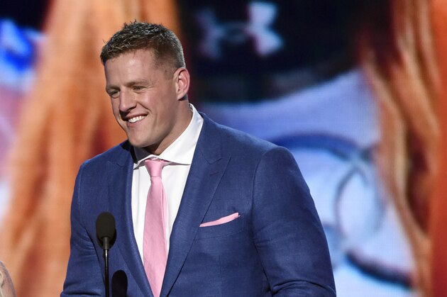 Britney Spears, left, and NFL player J.J. Watt, of the Houston Texans, present the best female athlete award at the ESPY Awards at the Microsoft Theater on Wednesday, July 15, 2015, in Los Angeles. (Photo by Chris Pizzello/Invision/AP)