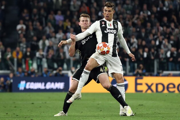 Juventus' Portuguese forward Cristiano Ronaldo (Front) holds off Ajax's Dutch defender Matthijs de Ligt during the UEFA Champions League quarter-final second leg football match Juventus vs Ajax Amsterdam on April 16, 2019 at the Juventus stadium in Turin. (Photo by Isabella BONOTTO / AFP)        (Photo credit should read ISABELLA BONOTTO/AFP/Getty Images)